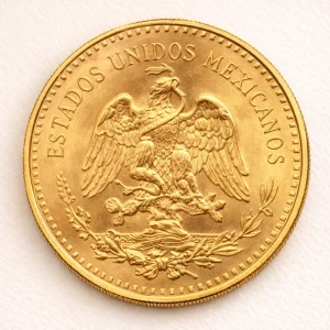 Mexican 50 Peso gold coin on a light premium studio background